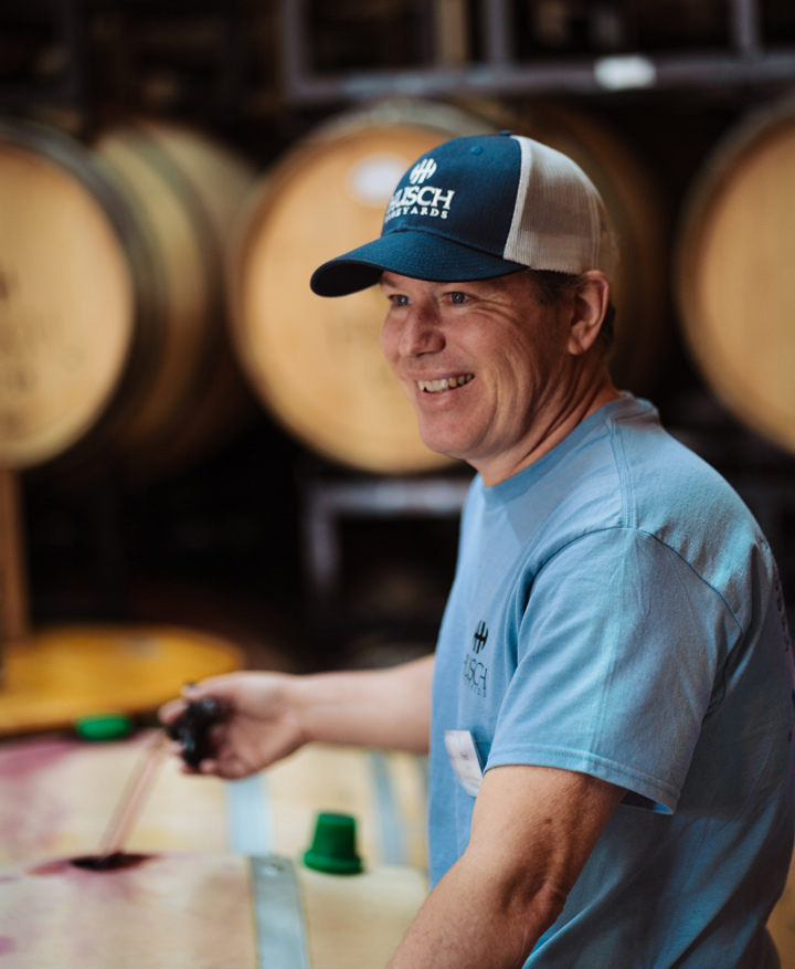 Winemaker Brad in the barrel room, wine thief in hand