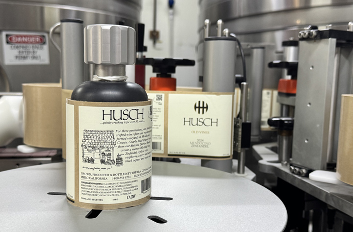 In the foreground, the new back label with an image of the tastingroom and wine description.