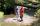 Two scientists, one in a wetsuit with a snorkel, survey the river from the bank.